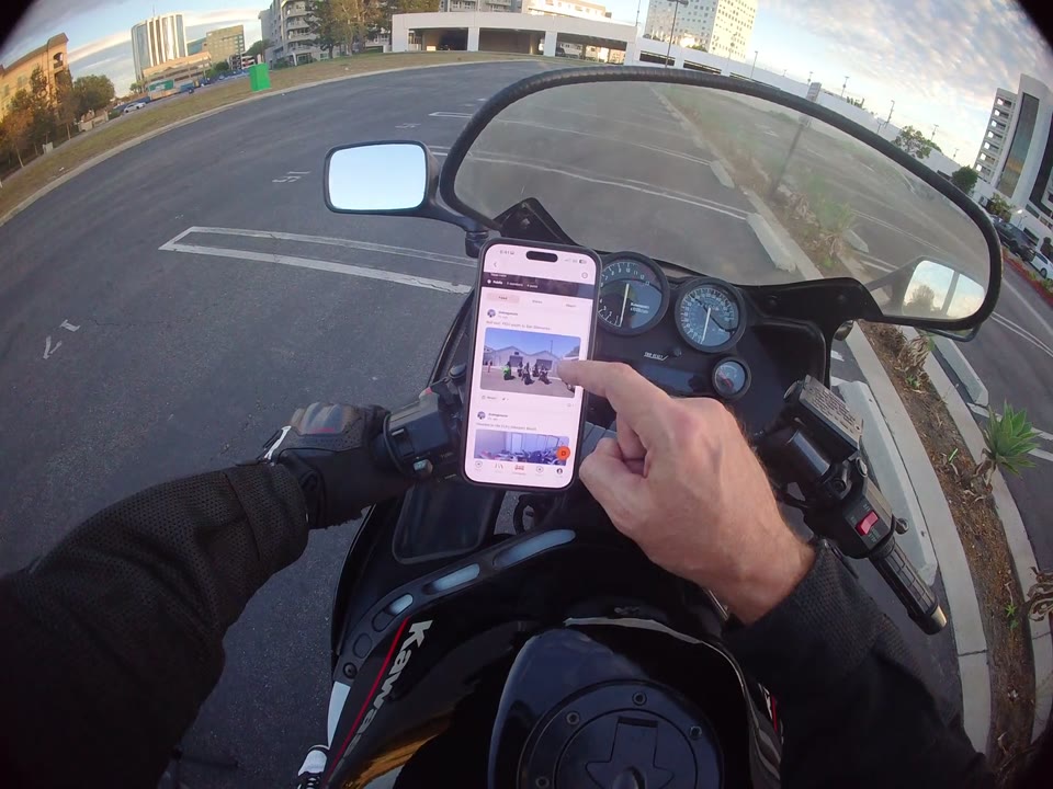 RiderShield community group posts shown on a motorcycle-mounted phone.