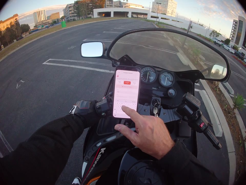 RiderShield emergency-contact settings on a phone while the rider is parked.