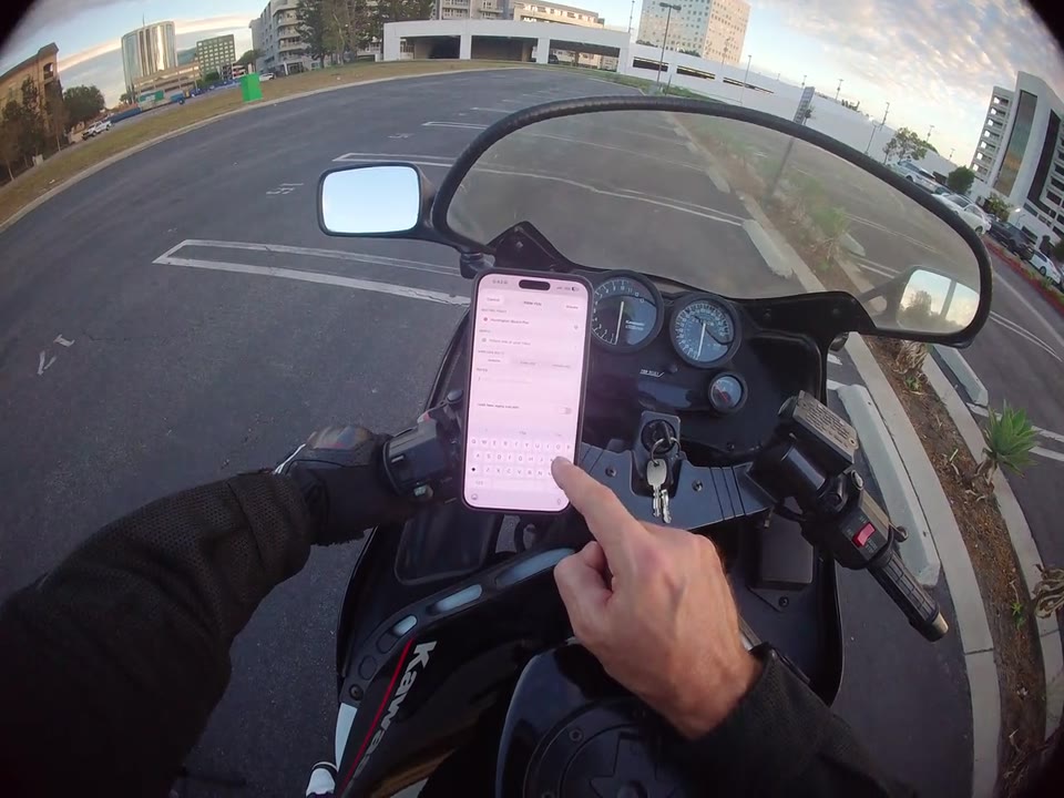A rider enters group ride details in RiderShield while parked.